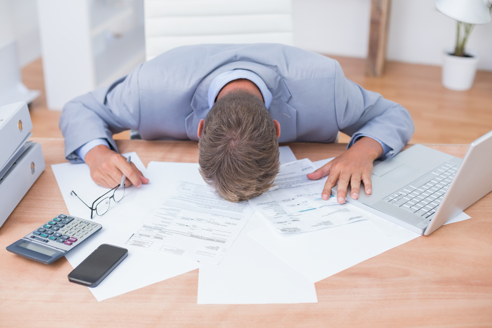 Businessman being depressed by accounting in his office